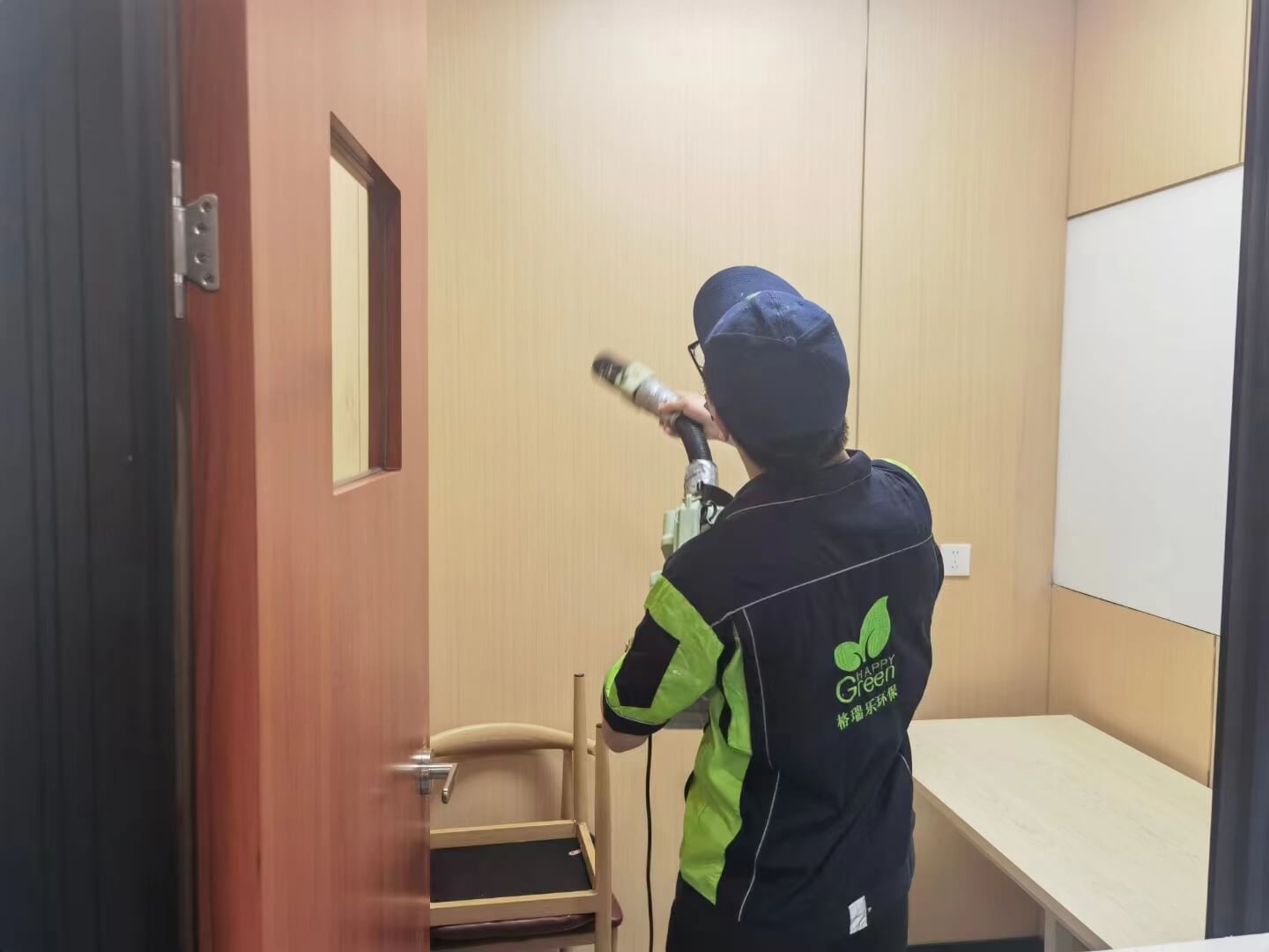 新房门口,格瑞乐施工团队身着统一工作服,手持针对家具除甲醛的工具和产品,准备入场。